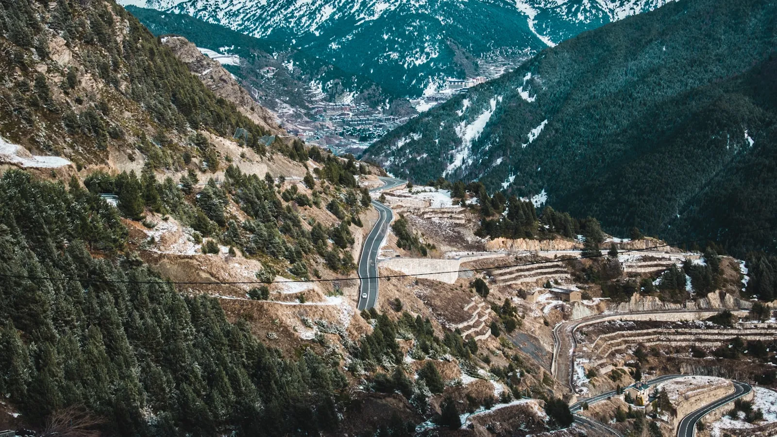 A scenic view of a winding road in the mountains