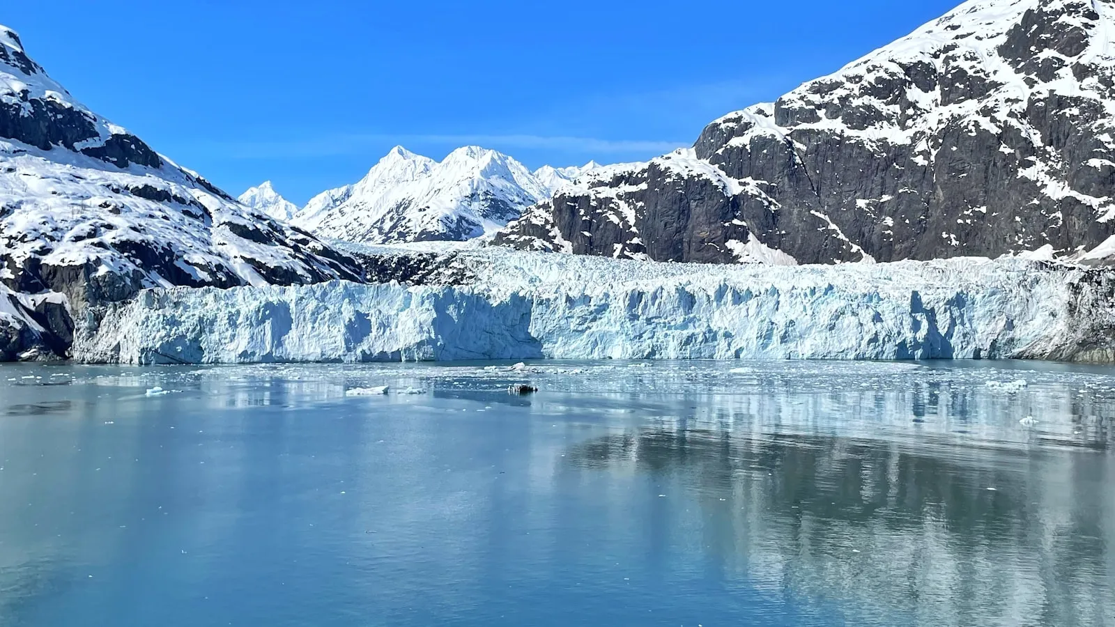 A large glacier with mountains in the background
