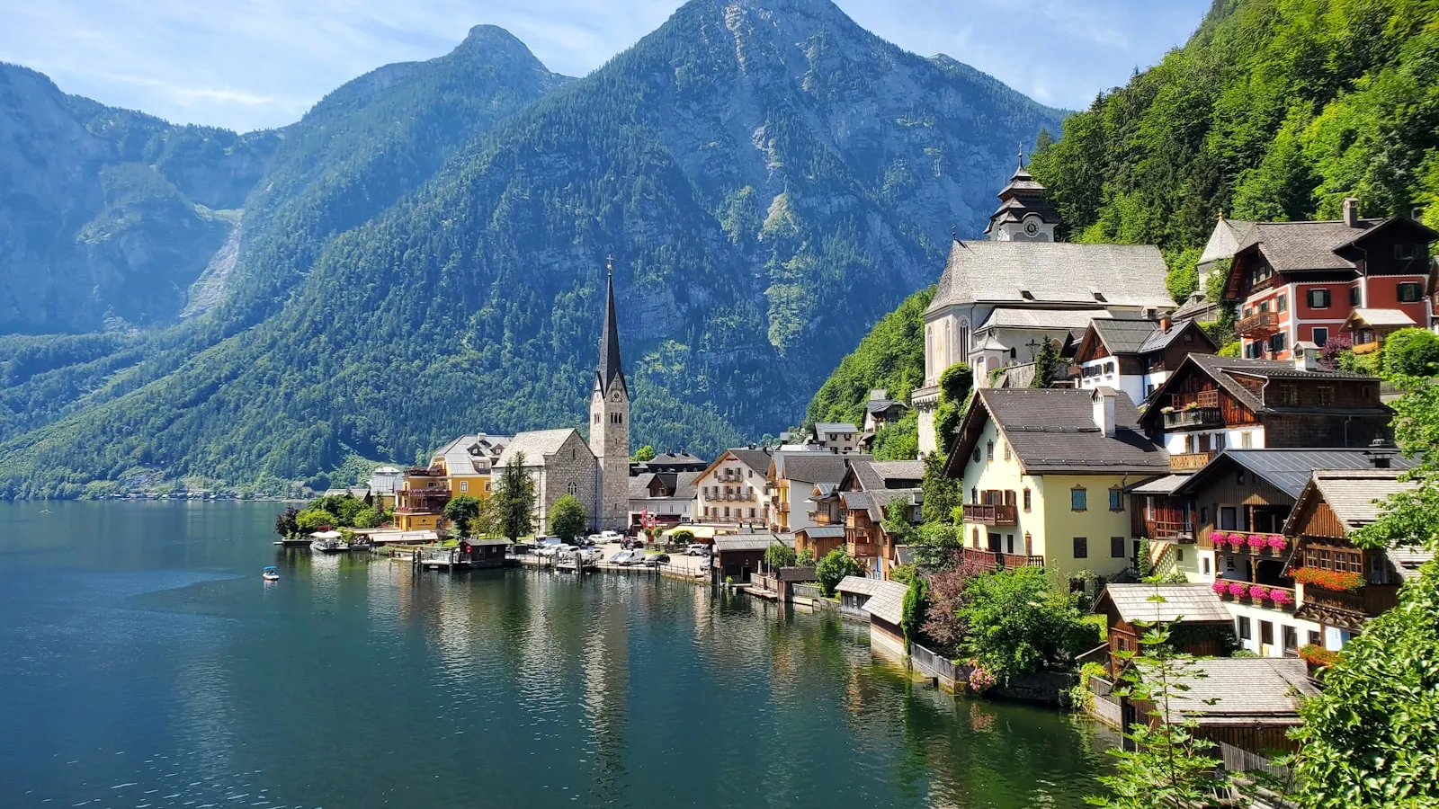 Houses near body of water and mountain during daytime