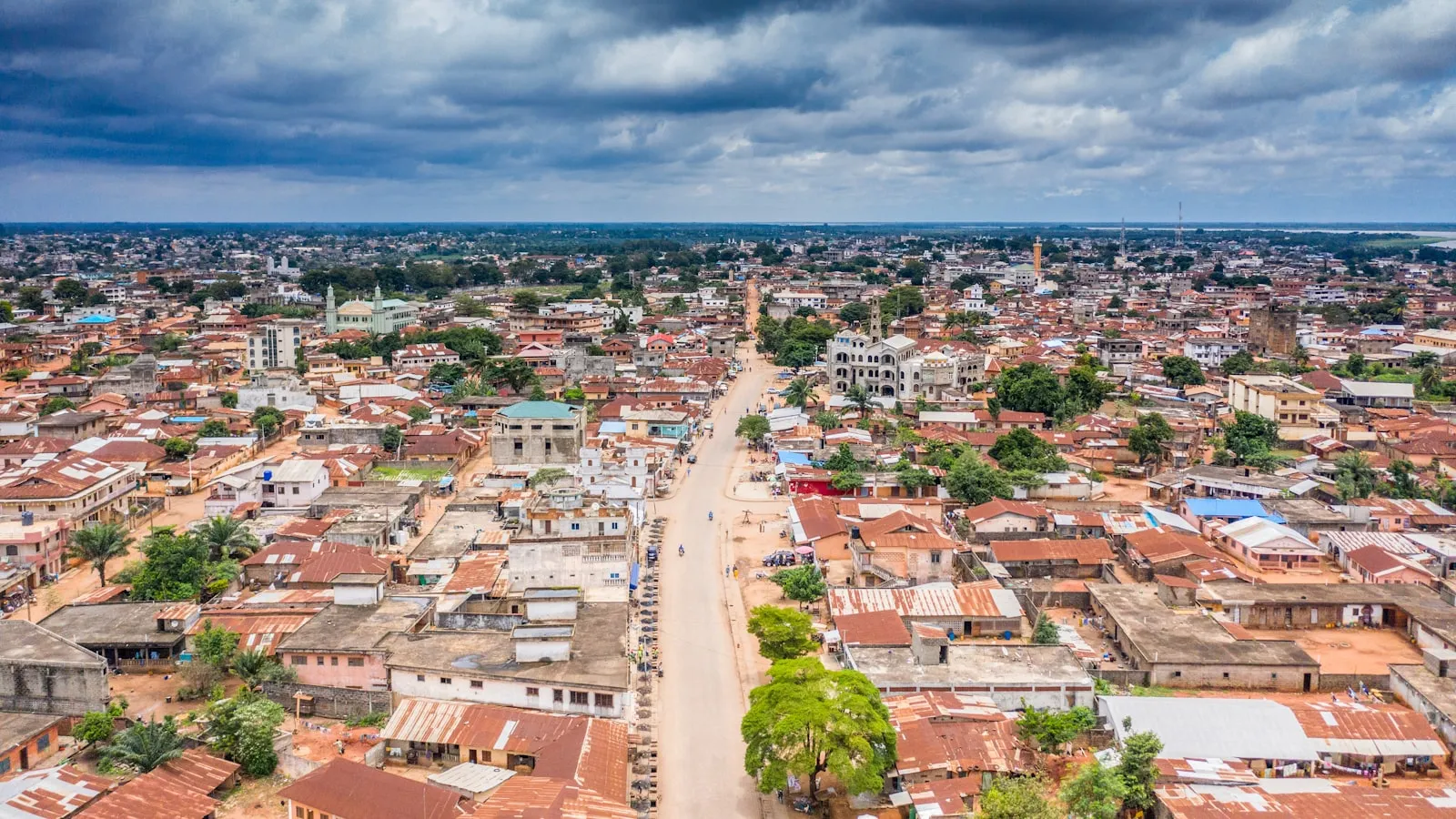 Aerial view of city buildings under cloudy sky during daytime