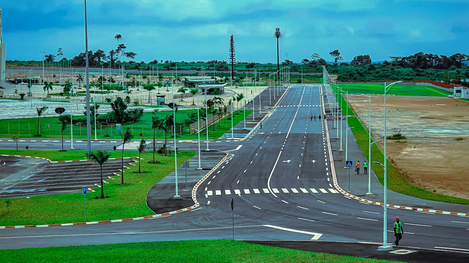 A long empty street with a sky background