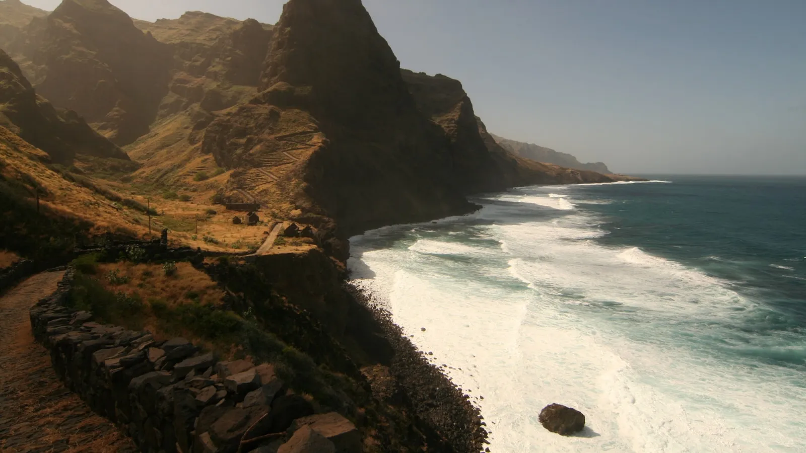 A scenic view of the ocean and mountains