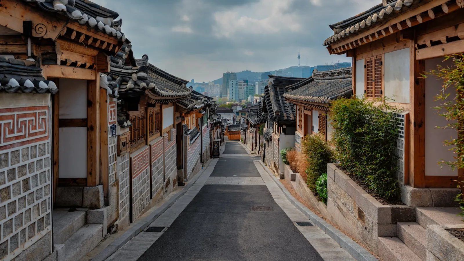 A street lined with wooden buildings under a cloudy sky