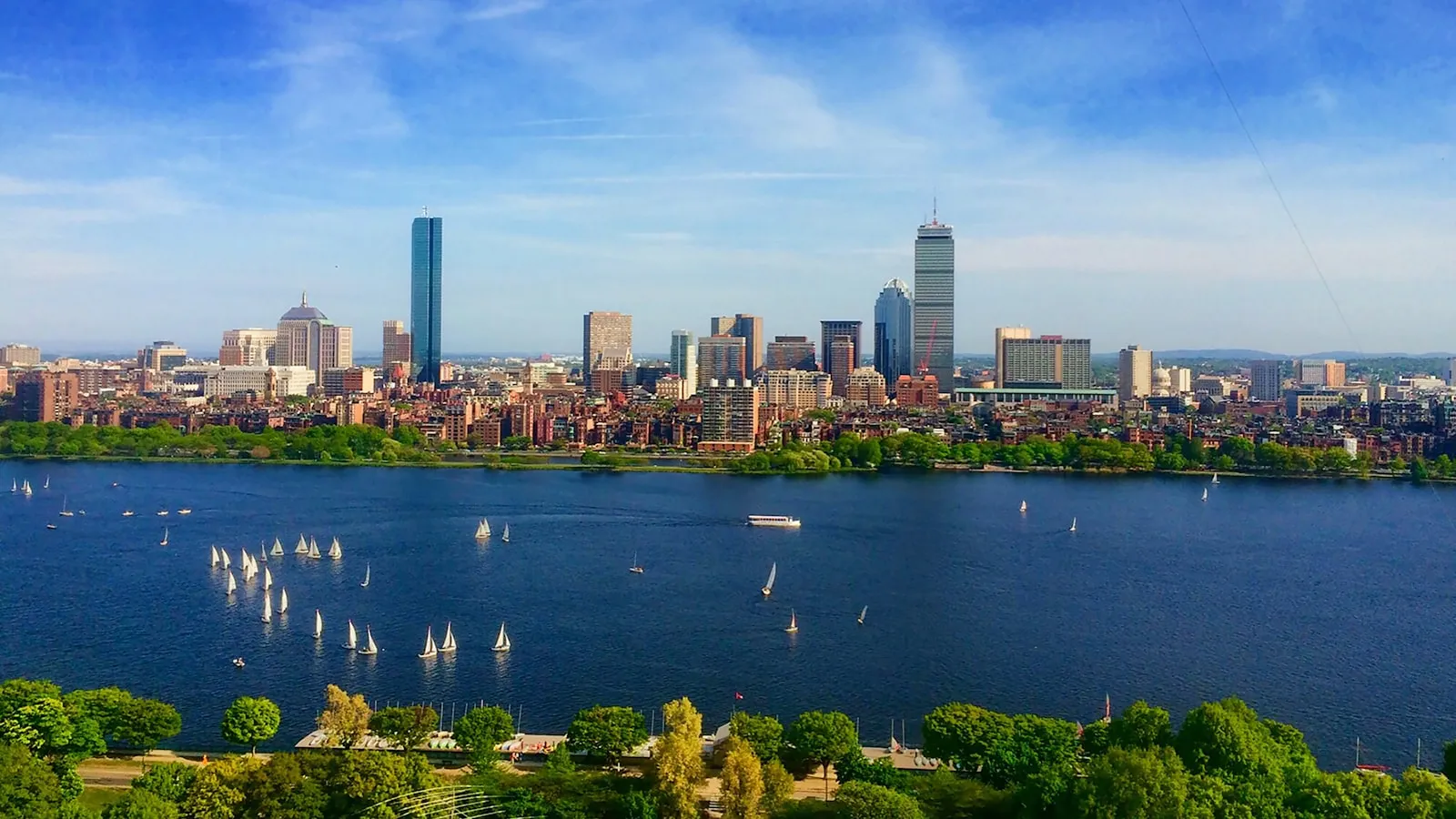 Body of water near cityscape at daytime