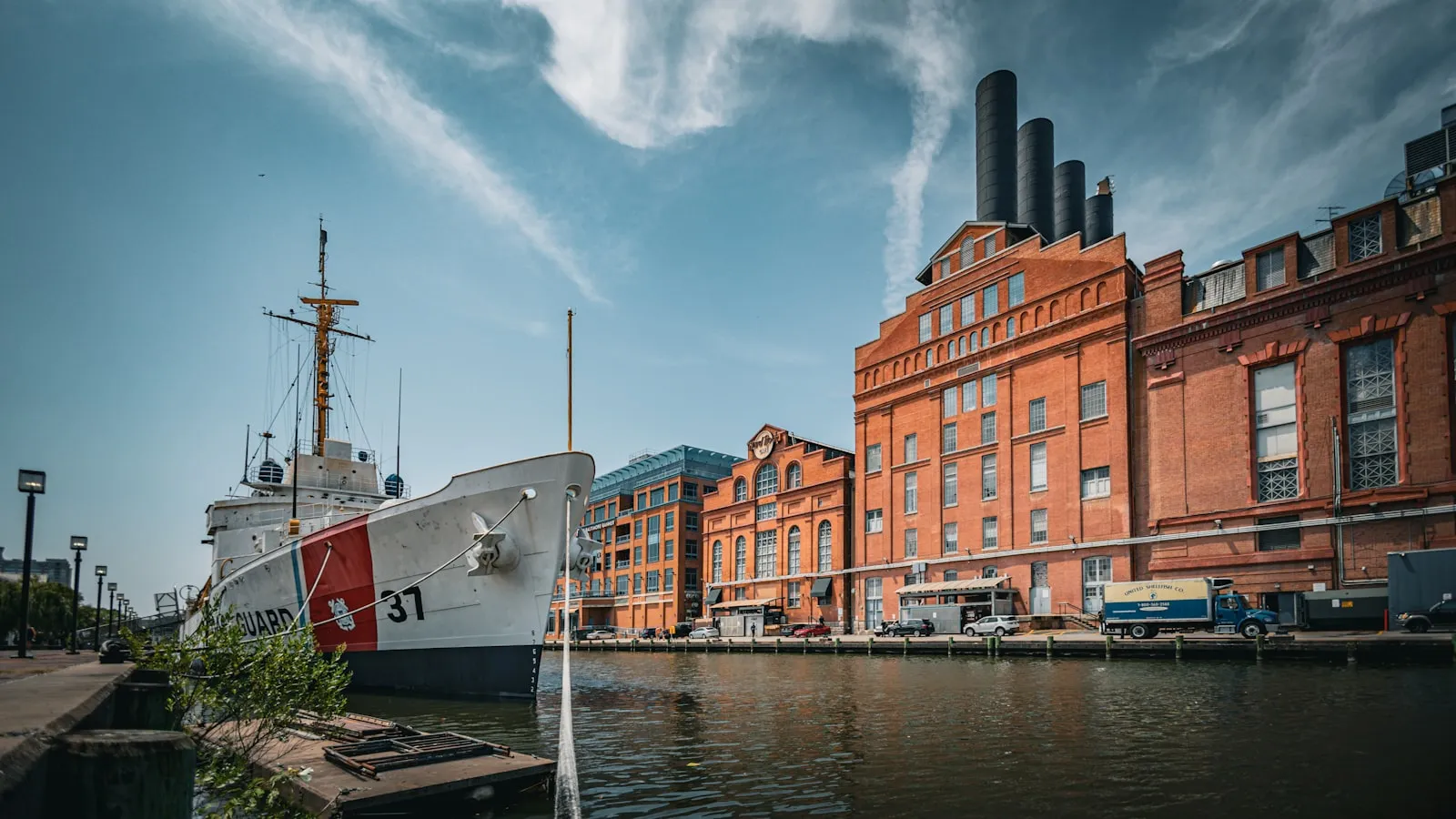 A large boat sitting in the water next to a building