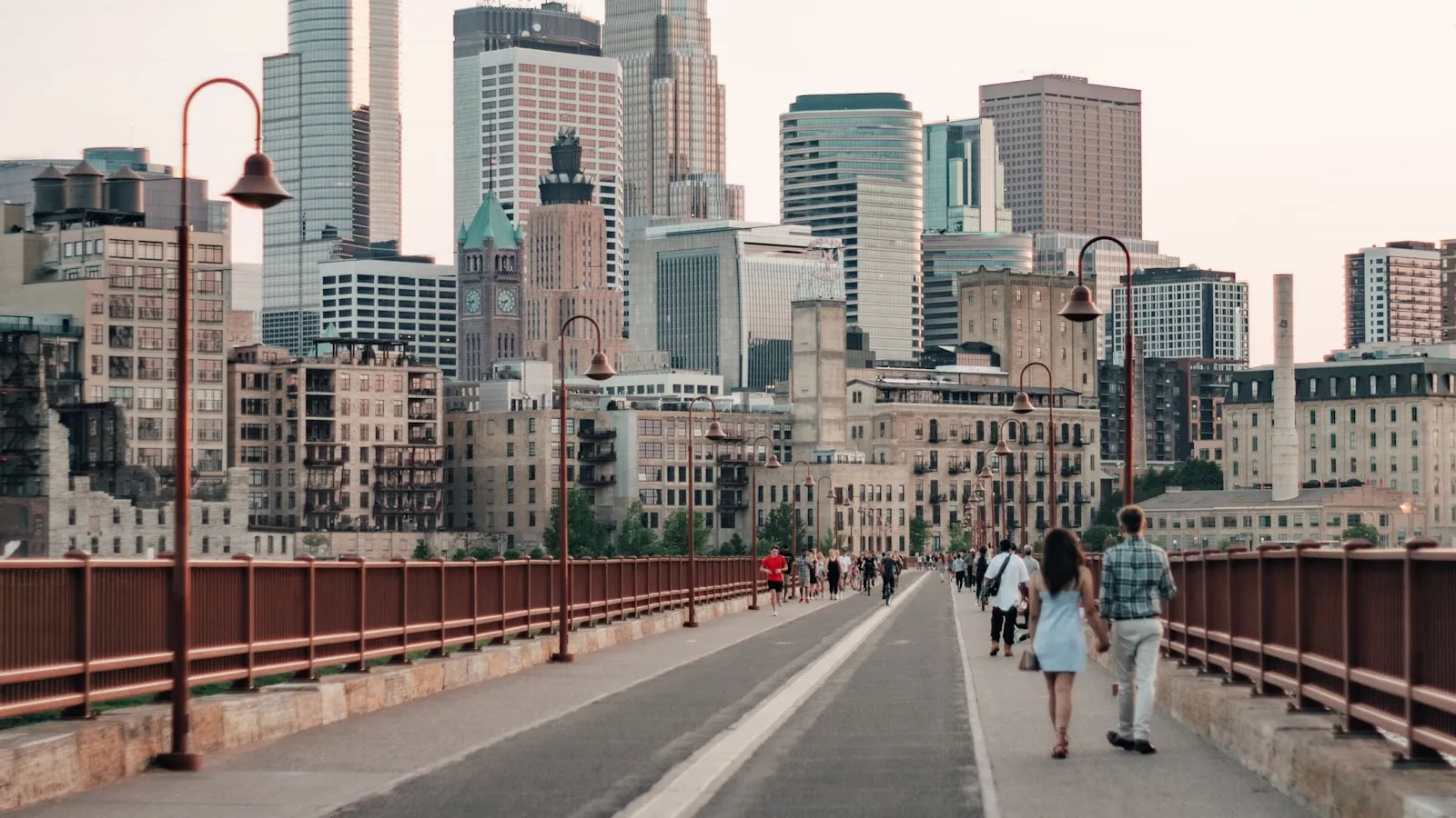 People walking on sidewalk near city buildings during daytime