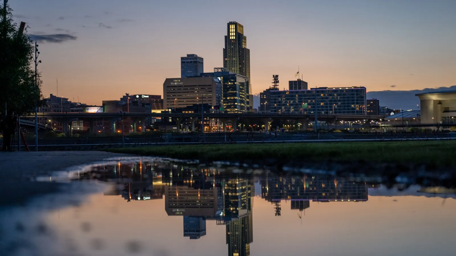 A city skyline is reflected in a body of water