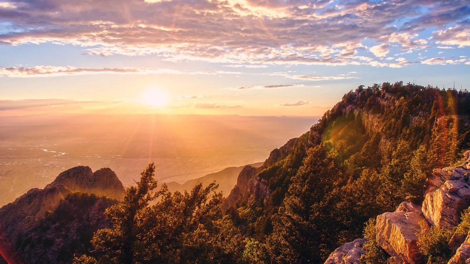 The sun is setting over a mountain range