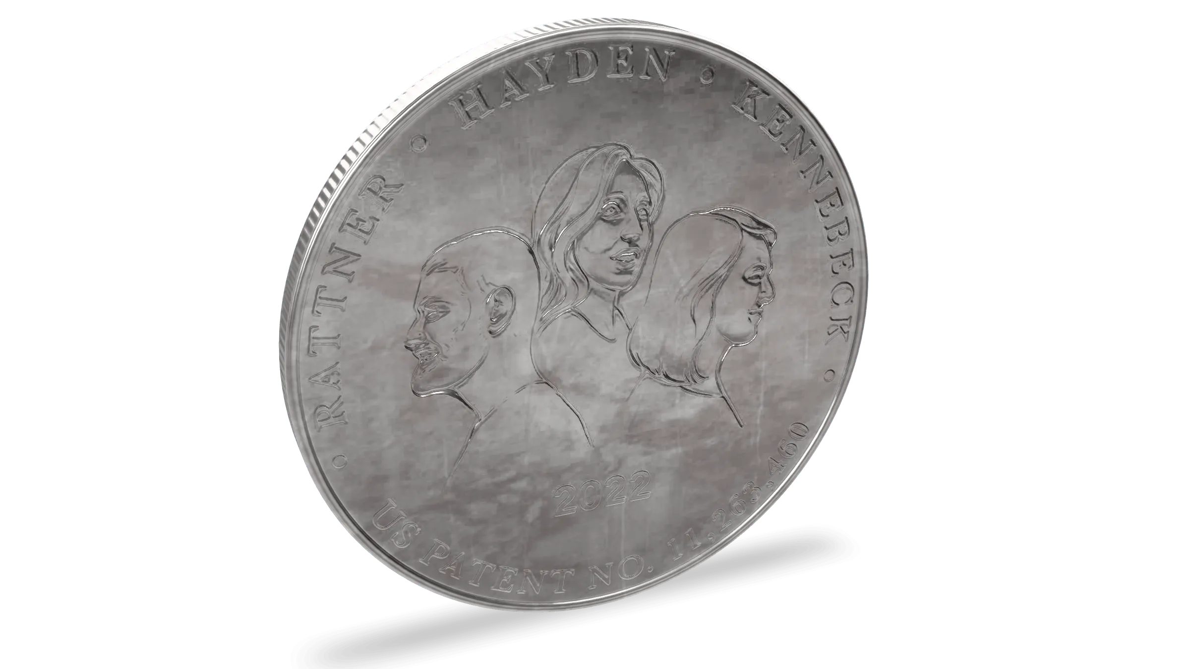 A struck silver coin turned to the light. Three portraits in relief sit above the year 2022, ringed by the names Rattner, Hayden, and Kennebeck and the words US Patent No. 11,263,460.