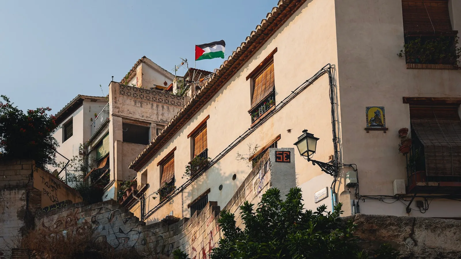 Buildings with a flag flying on a clear day.