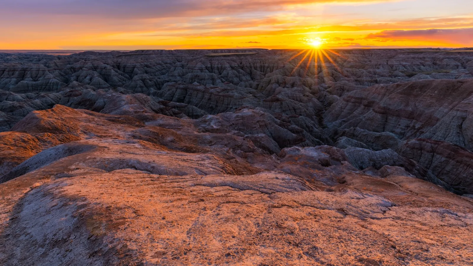 Brown rocky mountain during sunset