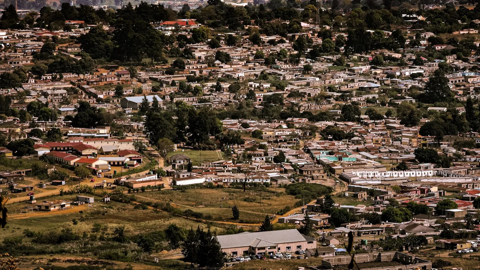 Dense urban settlement nestled in rolling hills.