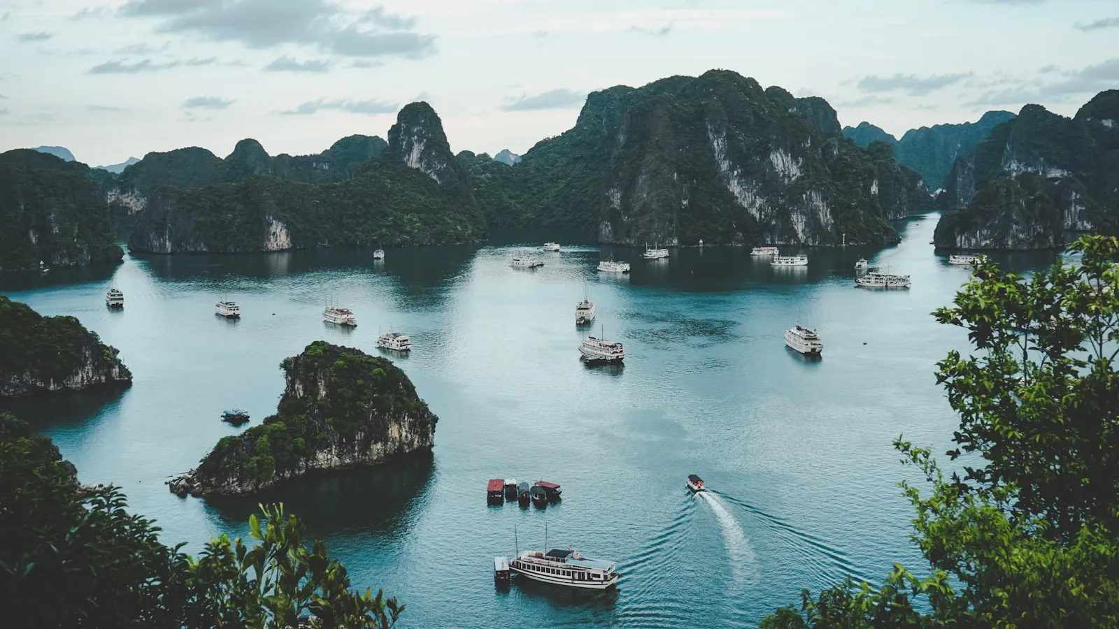 High-angle photography of boats on water near hill during daytime