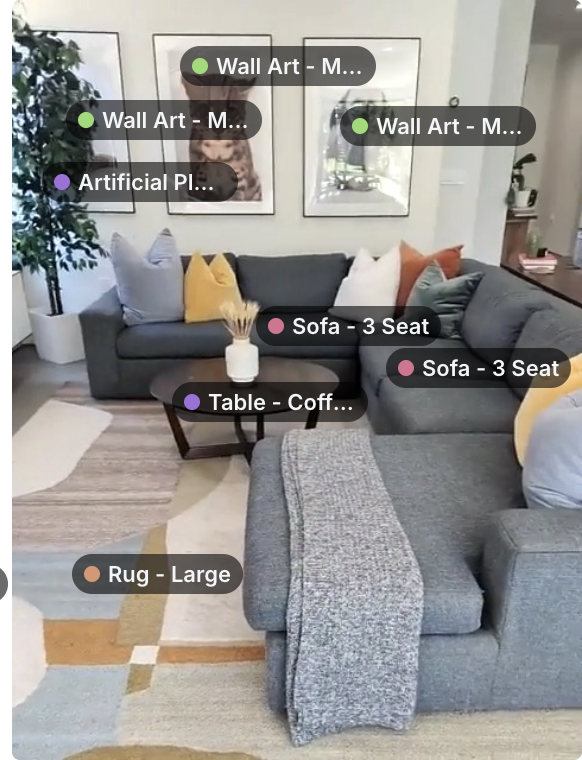 A living room with a three-seat sectional sofa, coffee table, rug, artificial plant and framed wall art, each labeled with its detected object type