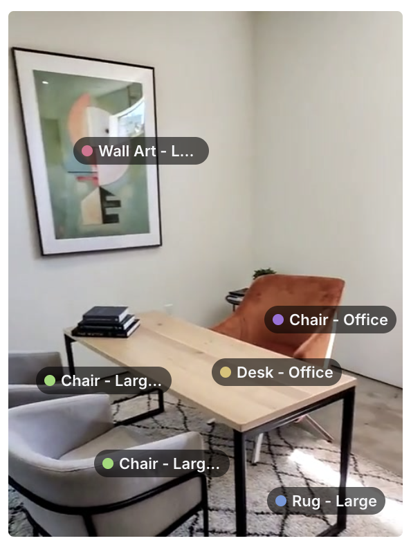A home office with a dining table used as a desk, two armchairs, an office chair, a rug and framed wall art, each labeled with its detected object type